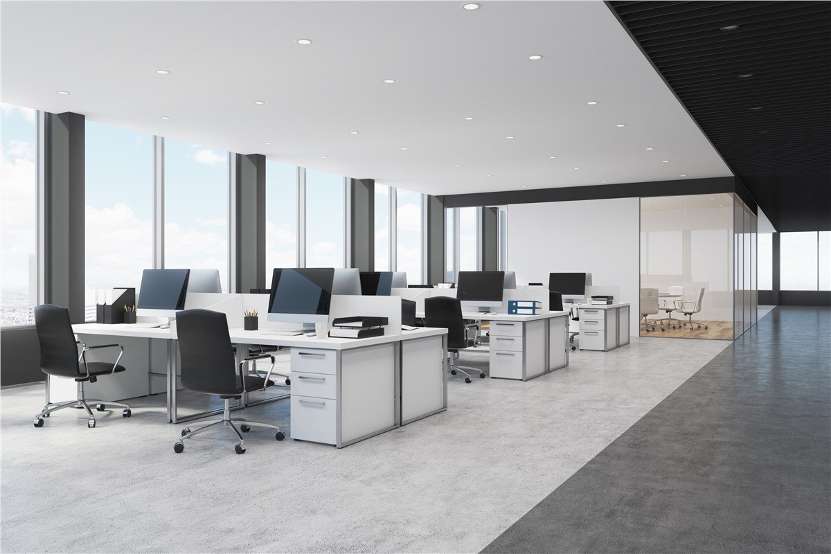 A bright, modern office showing a well-organized desk, ergonomic chair, storage cabinet, shelves, and clear walking space.