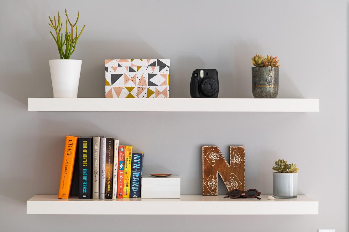 stylish small home decor items arranged on a shelf in a modern interior