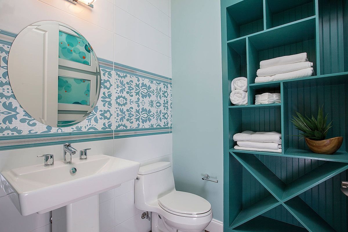 small modern bathroom with wall shelves, under-sink storage, baskets, and organized toiletries
