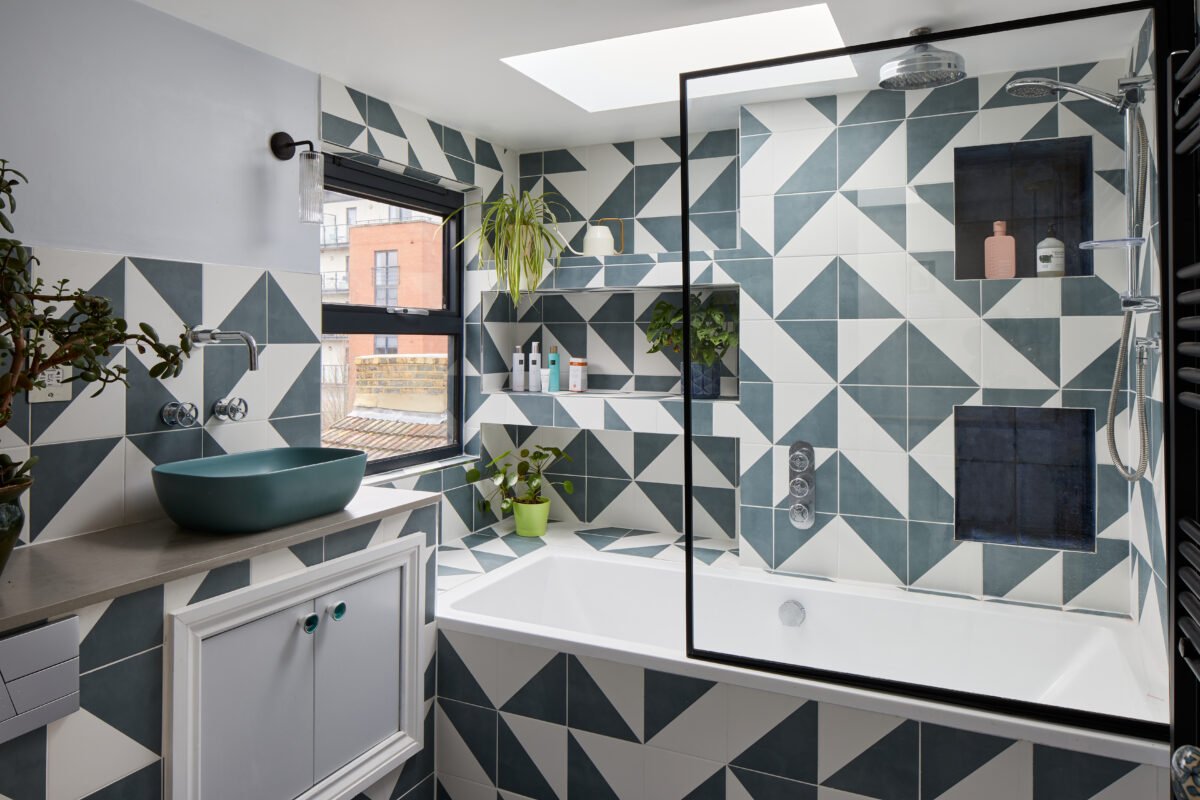 Modern bathroom featuring a black and white diamond tile floor layout and floating vanity.